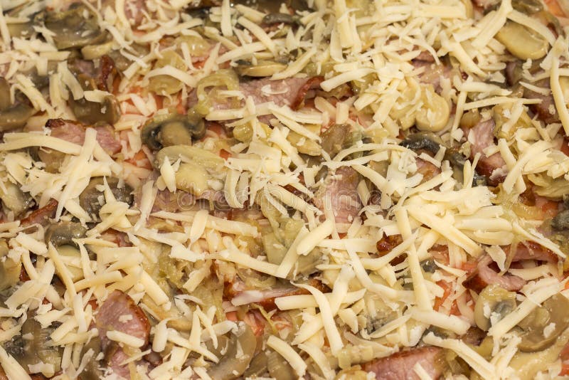 Unbaked pizza with bacon and mushrooms, close-up royalty free stock photo Unbaked pizza with bacon and mushrooms, close-up royalty free stock photo