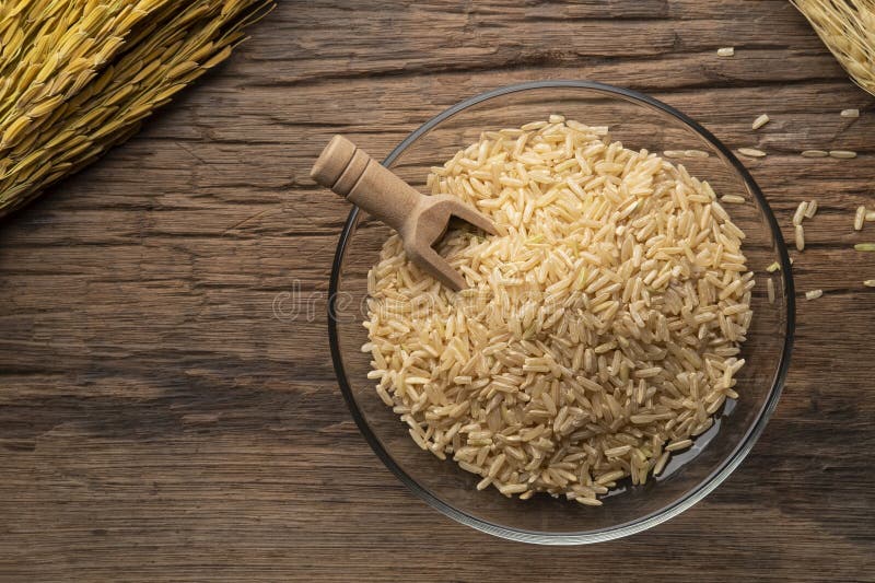 Uncooked Brown Rice or Unpolished Rice in Glass Plate Stock Photo