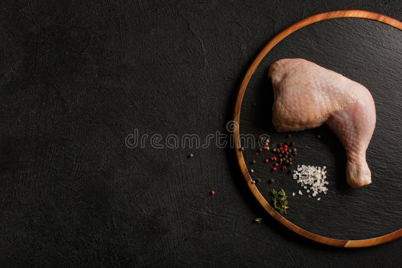 Uncooked Chicken Thigh on a Stone Kitchen Cutting Board. Stock Image