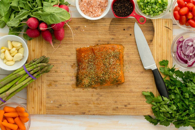 Uncooked fish fillet centered on cutting board stock image Uncooked fish fillet centered on cutting board stock image