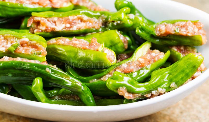 Uncooked Fresh Stuffed Green Peppers ready for cooking