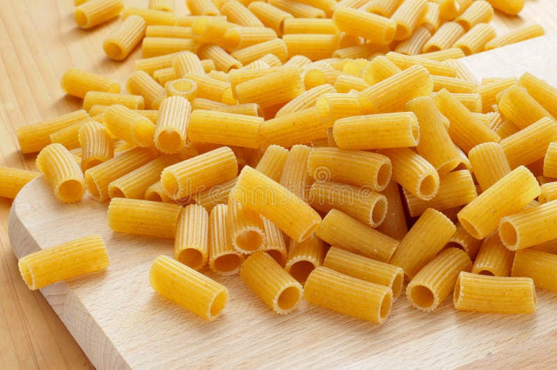 Uncooked penne pasta stock photo. Image of gastronomy 30874764