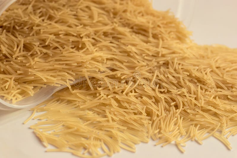 Uncooked Vermicelli, Scattered from Plastic Container Stock Photo