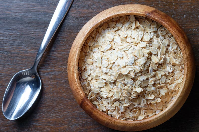 Uncooked Oatmeal Or Oat Flakes In A Wooden Bowl On A Pink Background ...