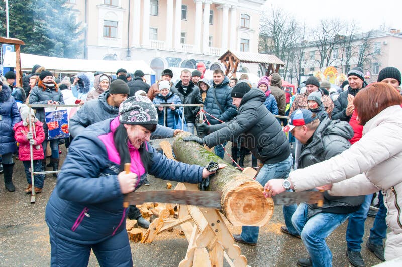 Undefined people take part in contest saw up the log during Maslenitsa celebration in Bryansk city.