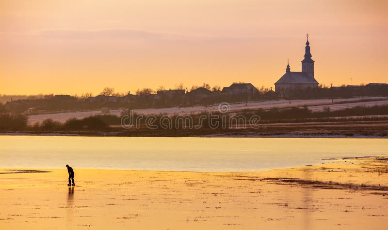 Undefined person skating on the frozen lake