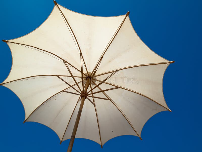 Under a white bamboo umbrella