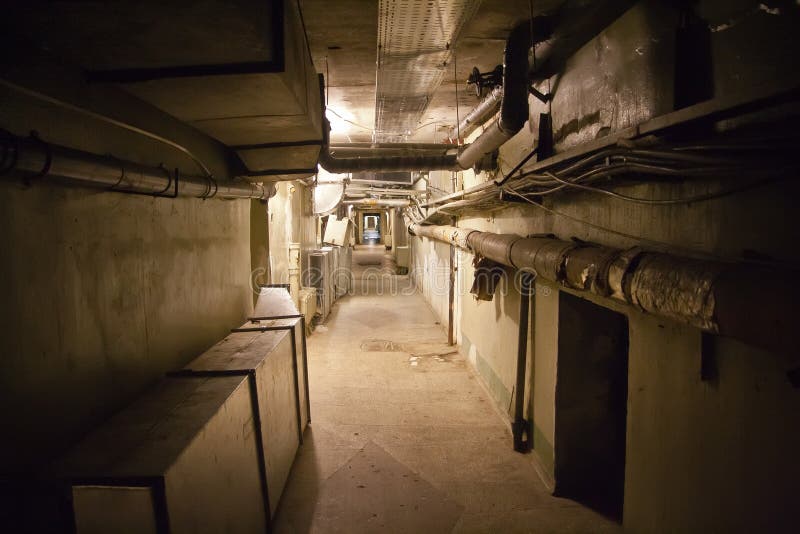 Underground Cellar with Water Heating Pipes and Cables Stock Photo