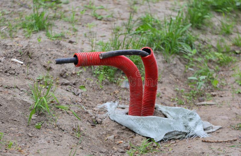 Underground Electrical Cables Coming Out of the Ground Stock Photo
