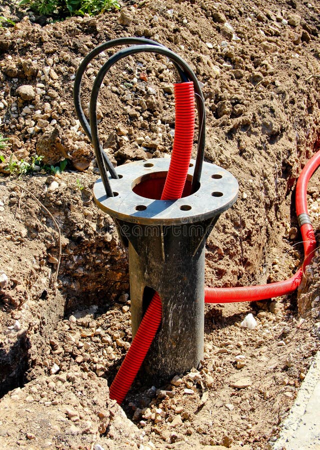 An underground part of a flange bearing of a light pole with power cables