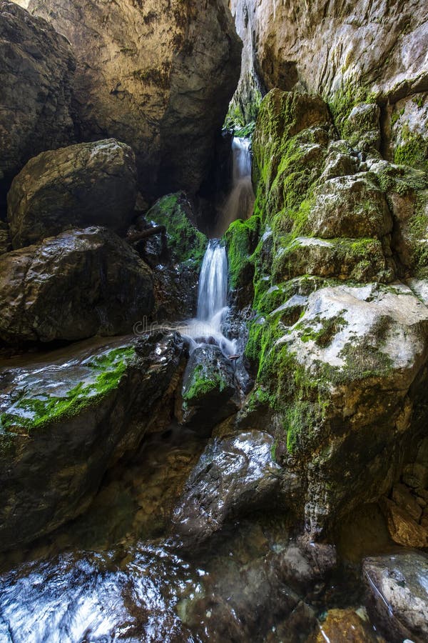 Underground river and waterfall in Romania. Underground river and waterfall from Cetatile Ponorului cave, Romania stock photo Underground river and waterfall in Romania. Underground river and waterfall from Cetatile Ponorului cave, Romania stock photo