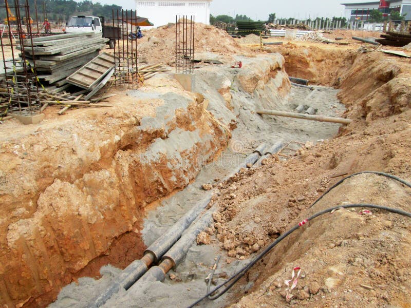 Underground Utility and Services Pipe Laid by Workers in the Trenches ...