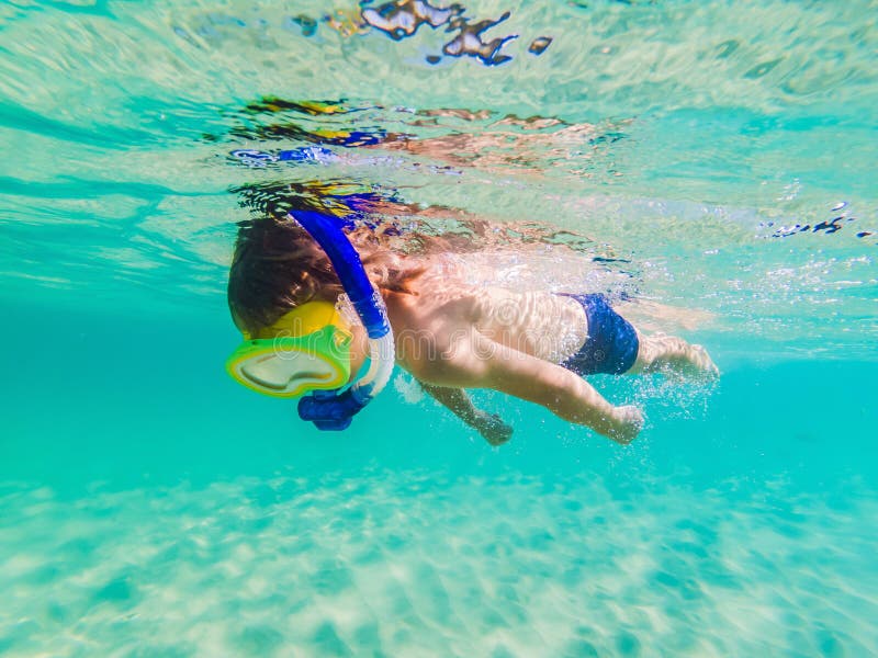 Underwater Nature Study, Boy Snorkeling in Clear Blue Sea Stock Photo