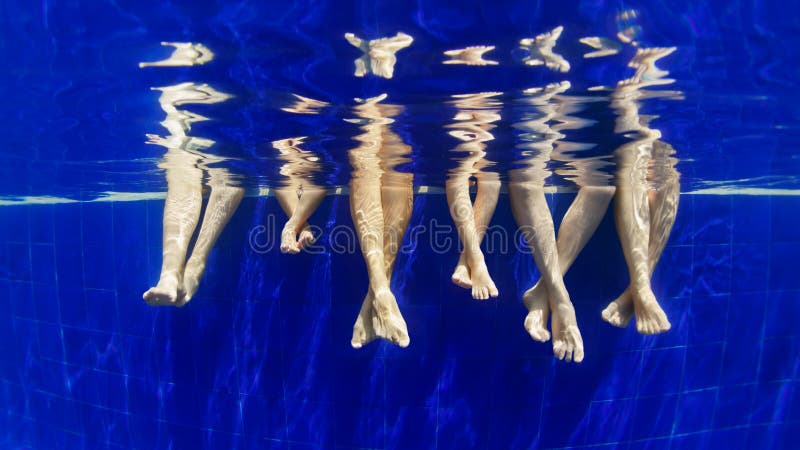 Underwater photo of bare feet in swimming pool