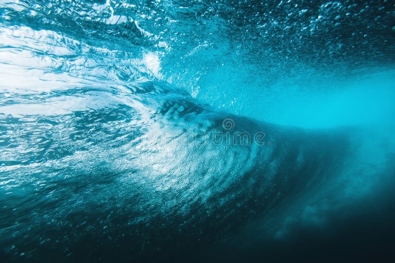 Underwater surfing wave in tropical ocean