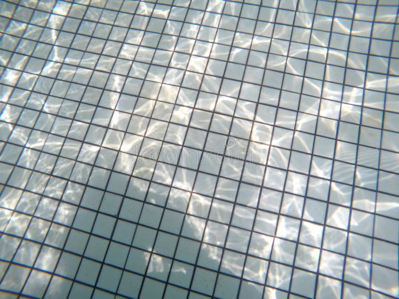 Underwater view of swimming pool floor with sunlight reflections stock images Underwater view of swimming pool floor with sunlight reflections stock images
