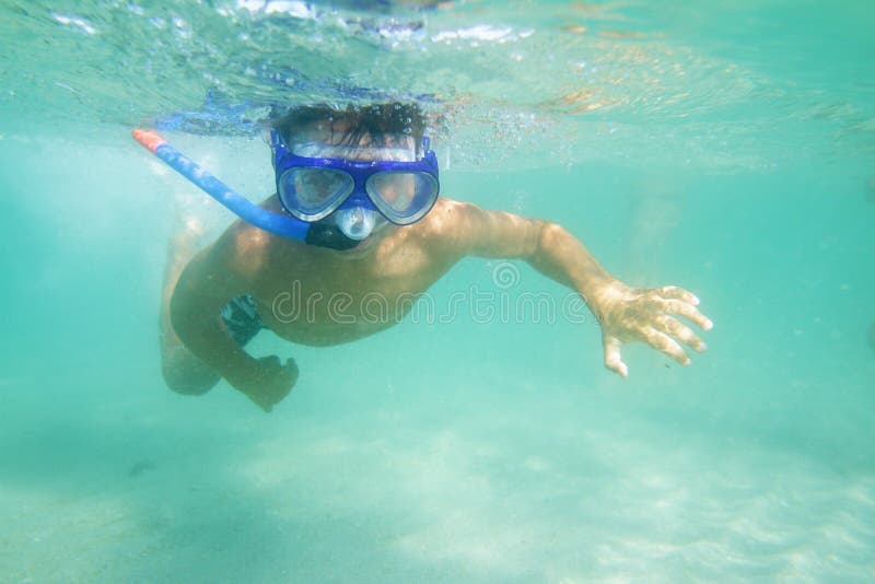 Underwater young boy diving