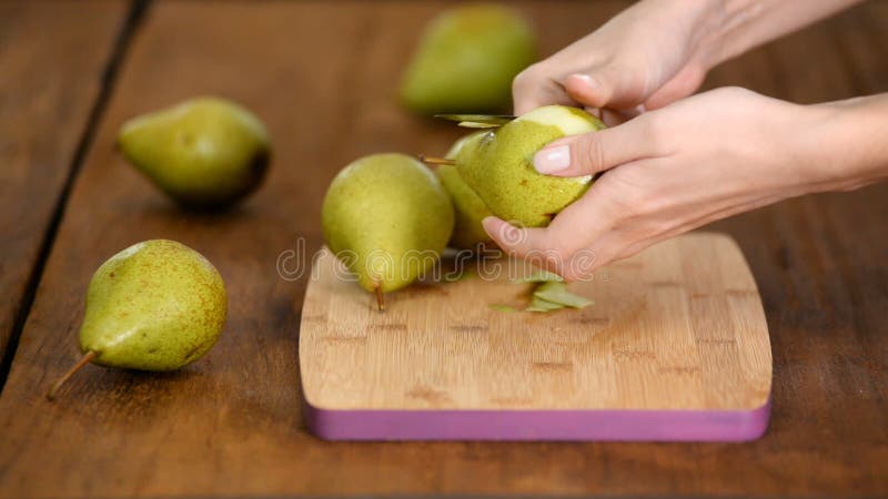 Fille Éplucher Une Pomme Sur La Table Banque D'Images et Photos