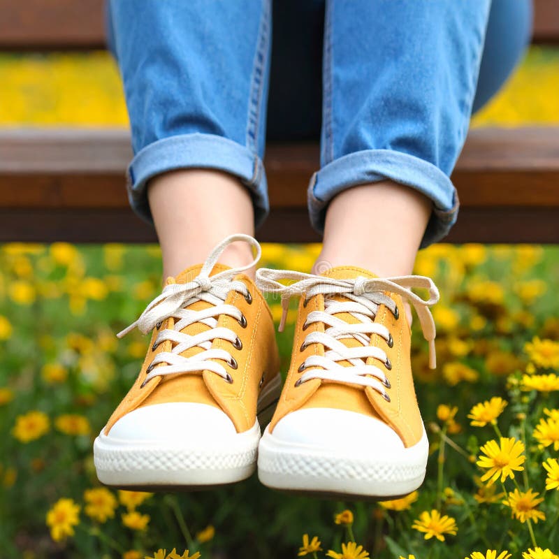 Une femme se reposant avec ses jambes soutenue sur un banc au milieu d'un champ de jaune illustration stock