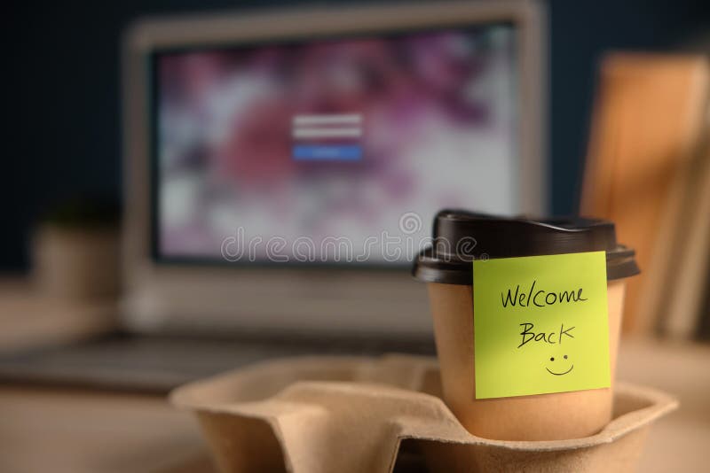 Back to Work Concept. Closeup of Welcome Note on Takeaway Coffee Cup in Office Desk. Message from a Colleague or Boss. Back to Work Concept. Closeup of Welcome Note on Takeaway Coffee Cup in Office Desk. Message from a Colleague or Boss