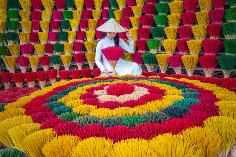 Une jeune asiatique en costume ao dai visite un village de fabrication d'encens à hue vietnam photos stock