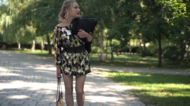 Une jeune mariée épuisée en colère se promenant dans le parc ensoleillé d'été le matin en parlant. portrait d'irritée banque de vidéos