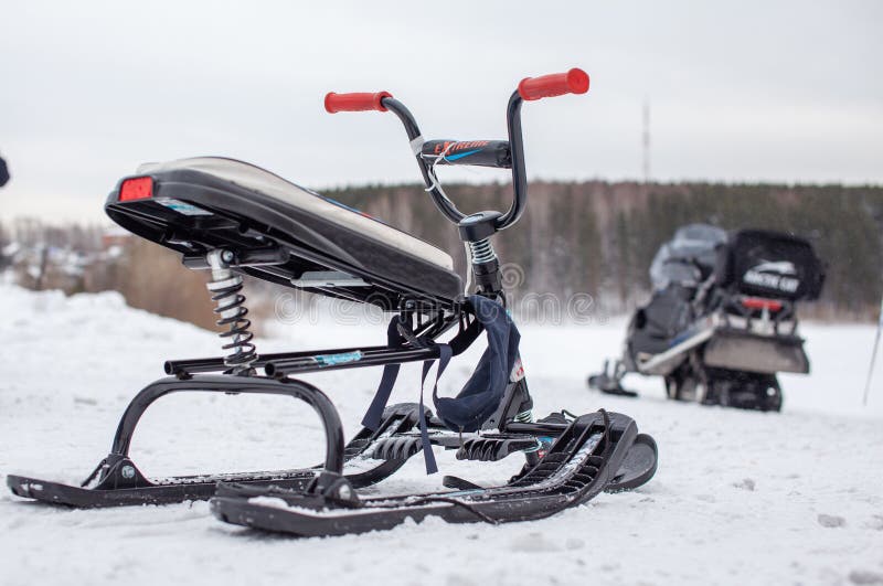 The children's snowmobile is ready for children to ride. Entertainment activities for children riding in the snow in winter. The children's snowmobile is ready for children to ride. Entertainment activities for children riding in the snow in winter