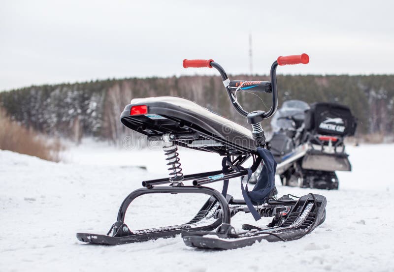 The children's snowmobile is ready for children to ride. Entertainment activities for children riding in the snow in winter. The children's snowmobile is ready for children to ride. Entertainment activities for children riding in the snow in winter