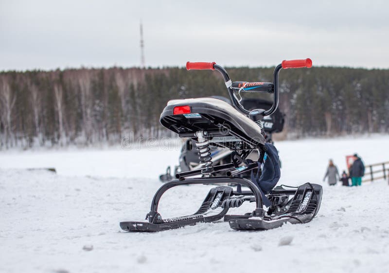 The children's snowmobile is ready for children to ride. Entertainment activities for children riding in the snow in winter. The children's snowmobile is ready for children to ride. Entertainment activities for children riding in the snow in winter