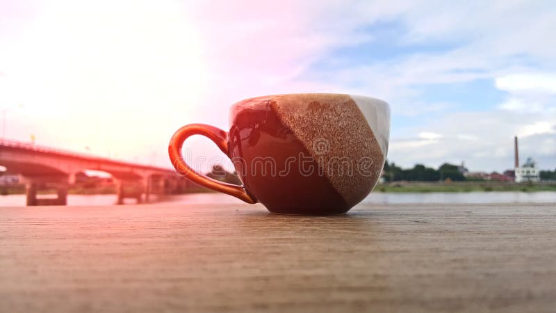 Une tasse de café est placée sur un plancher en bois pendant le matin image libre de droits Une tasse de café est placée sur un plancher en bois pendant le matin image libre de droits
