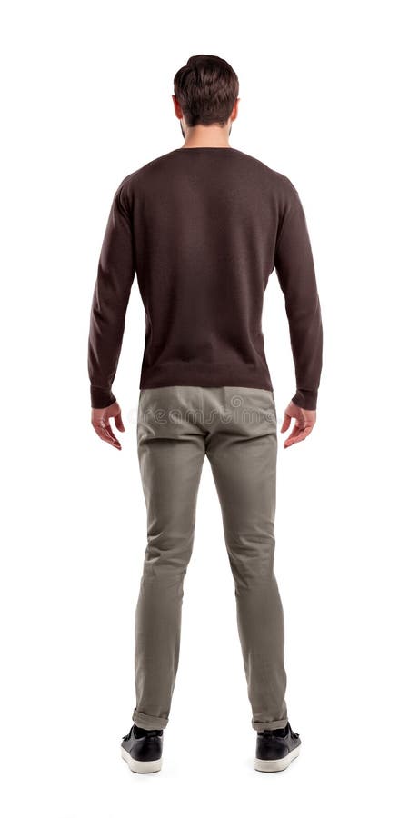 Une vue arrière sur un ajustement moderne et un homme en passant vêtu qui se tient dans une posture décontractée complètement dro image stock Une vue arrière sur un ajustement moderne et un homme en passant vêtu qui se tient dans une posture décontractée complètement dro image stock