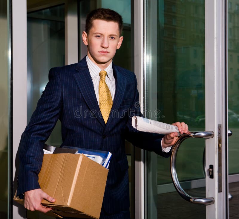 Unemployed young manager leaving business center