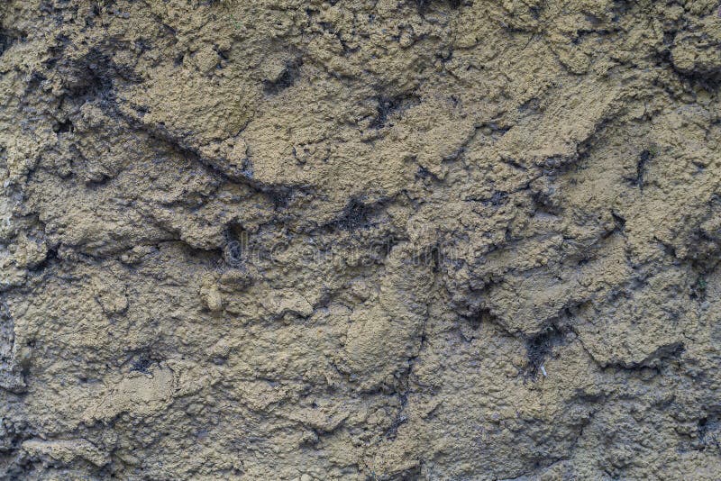 Uneven surface of wall plaster with deep hollows that are clogged with cobwebs, dust and small debris royalty free stock images