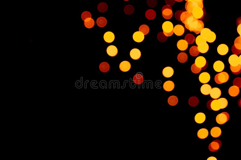 Unfocused abstract gold bokeh on black background. defocused and blurred many round light stock photos