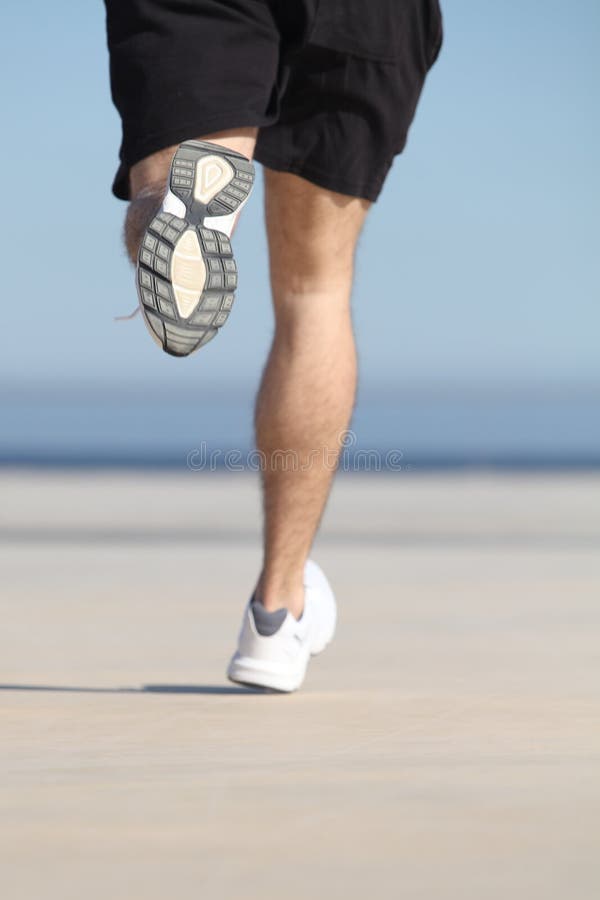 Unfocused Man Legs Running On The Concrete Of A Seafront Stock Image
