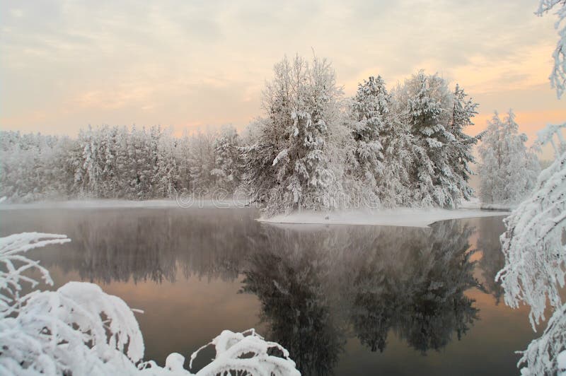 Unfrozen lake in the winter forests