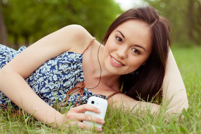 Ung asiatisk tonåring som använder smartphonen