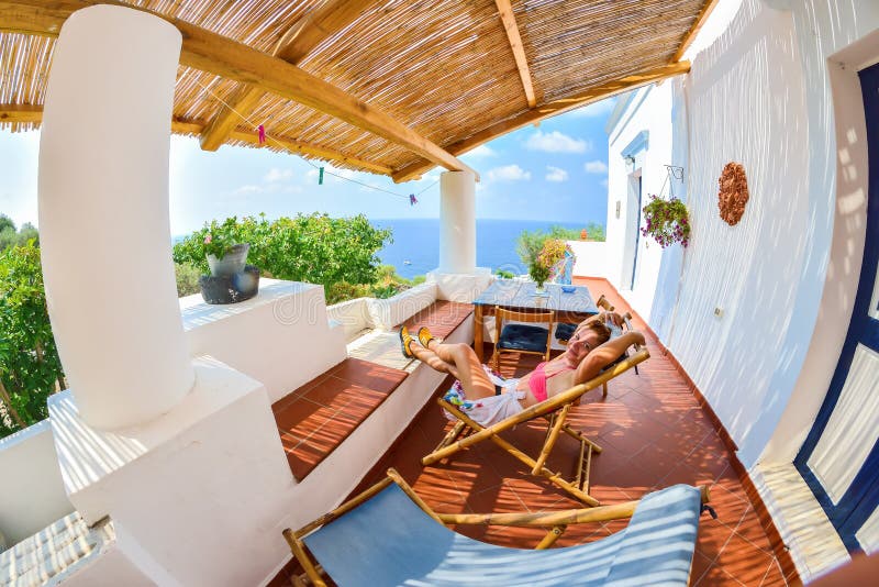 Ung kvinnlig turist som tycker om solen i Stromboli arkivbild Ung kvinnlig turist som tycker om solen i Stromboli arkivbild