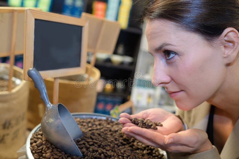 Young pretty woman with roasted coffee beans female. Young pretty woman with roasted coffee beans female