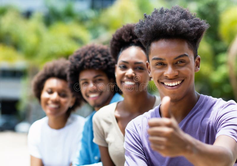 African american young adult men with friends showing thumb up outdoor in city in summer. African american young adult men with friends showing thumb up outdoor in city in summer