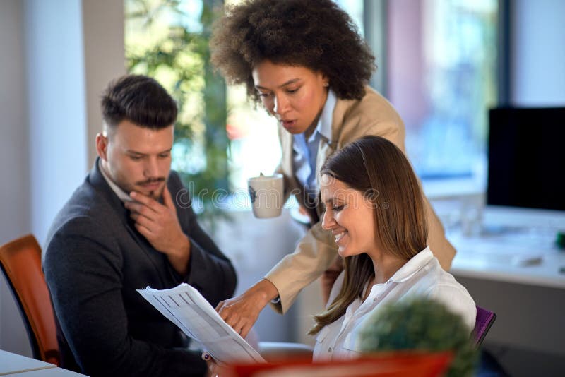 Young colleagues discussing and consulting in the office. Young colleagues discussing and consulting in the office