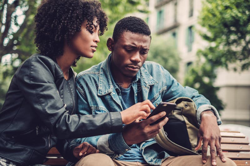 Young happy black couple in a park. Young happy black couple in a park