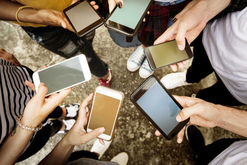 Young adults using smartphones in a circle social media and connection concept. Young adults using smartphones in a circle social media and connection concept