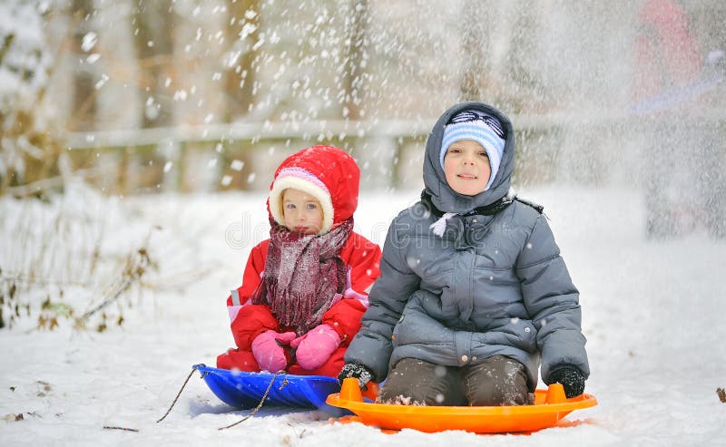 Kids sit on sled in winter time. Kids sit on sled in winter time