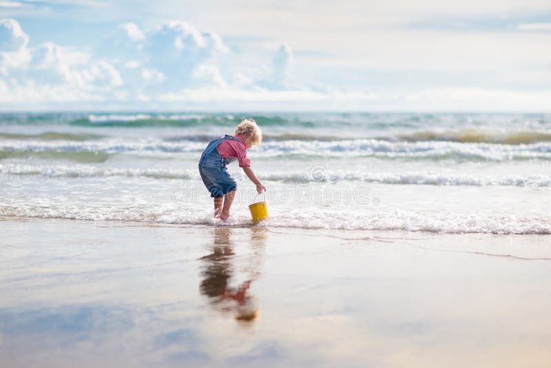 Ungelek p? den tropiska stranden Sand- och vattenleksak arkivfoton Ungelek p? den tropiska stranden Sand- och vattenleksak arkivfoton