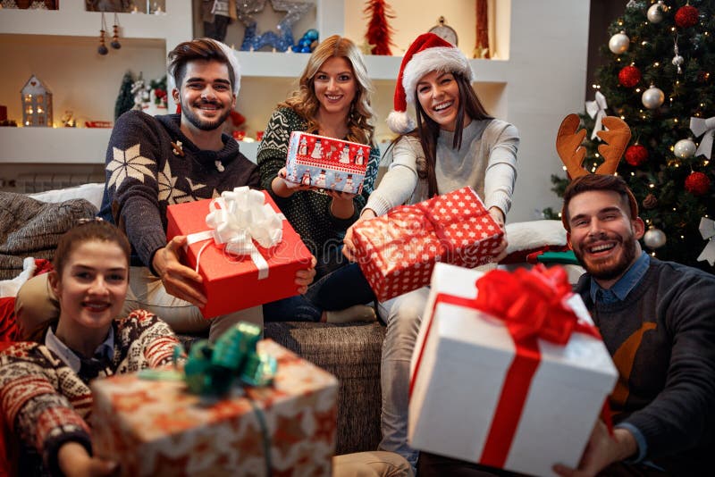 Ungt lyckligt folk med gåvor för jul royaltyfria foton Ungt lyckligt folk med gåvor för jul royaltyfria foton