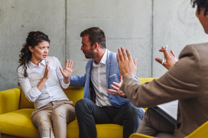 Young married couple at their counselor. Marriage problems. Fighting stock photos Young married couple at their counselor. Marriage problems. Fighting stock photos