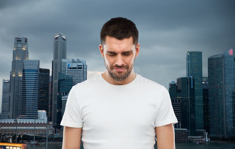 Unhappy man over evening singapore city background.