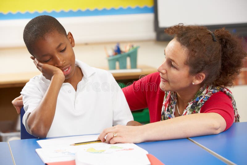 Unhappy Schoolboy Studying In Classroom royalty free stock photography Unhappy Schoolboy Studying In Classroom royalty free stock photography