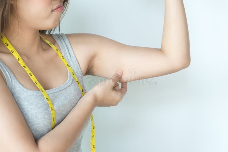 Fat beautiful woman pulls cellulite under her arms with a measuring tape.  excess fat under the arms. healthy weight control concept 13095035 Stock  Photo at Vecteezy